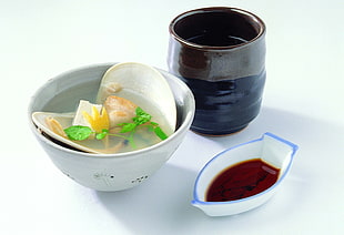 shell soup in white bowl near sauce